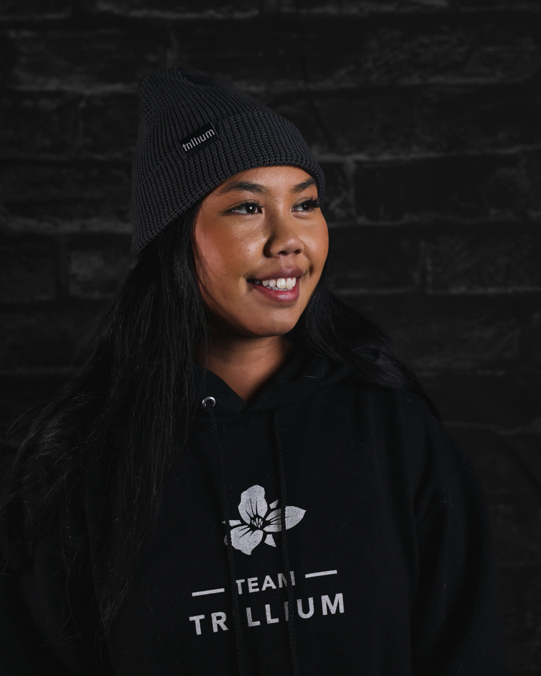 Woman wearing Trillium gray knit beanie in Charcoal Grey