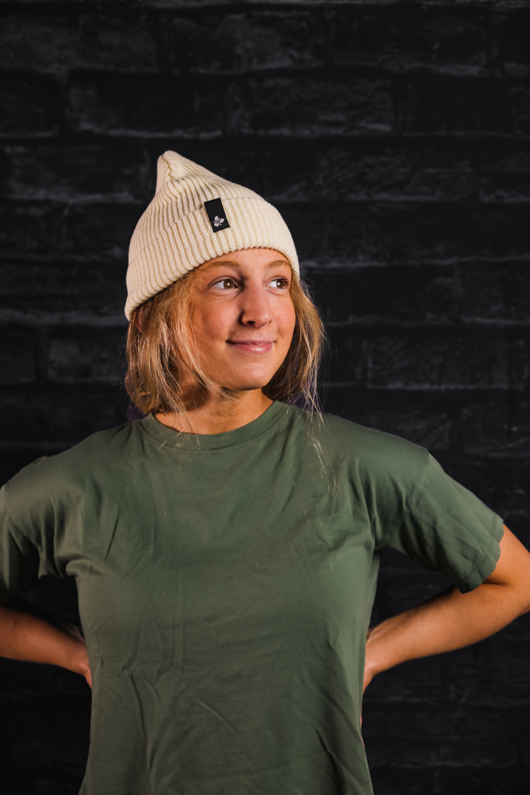 Woman wearing Trillium Knit beanie in cream