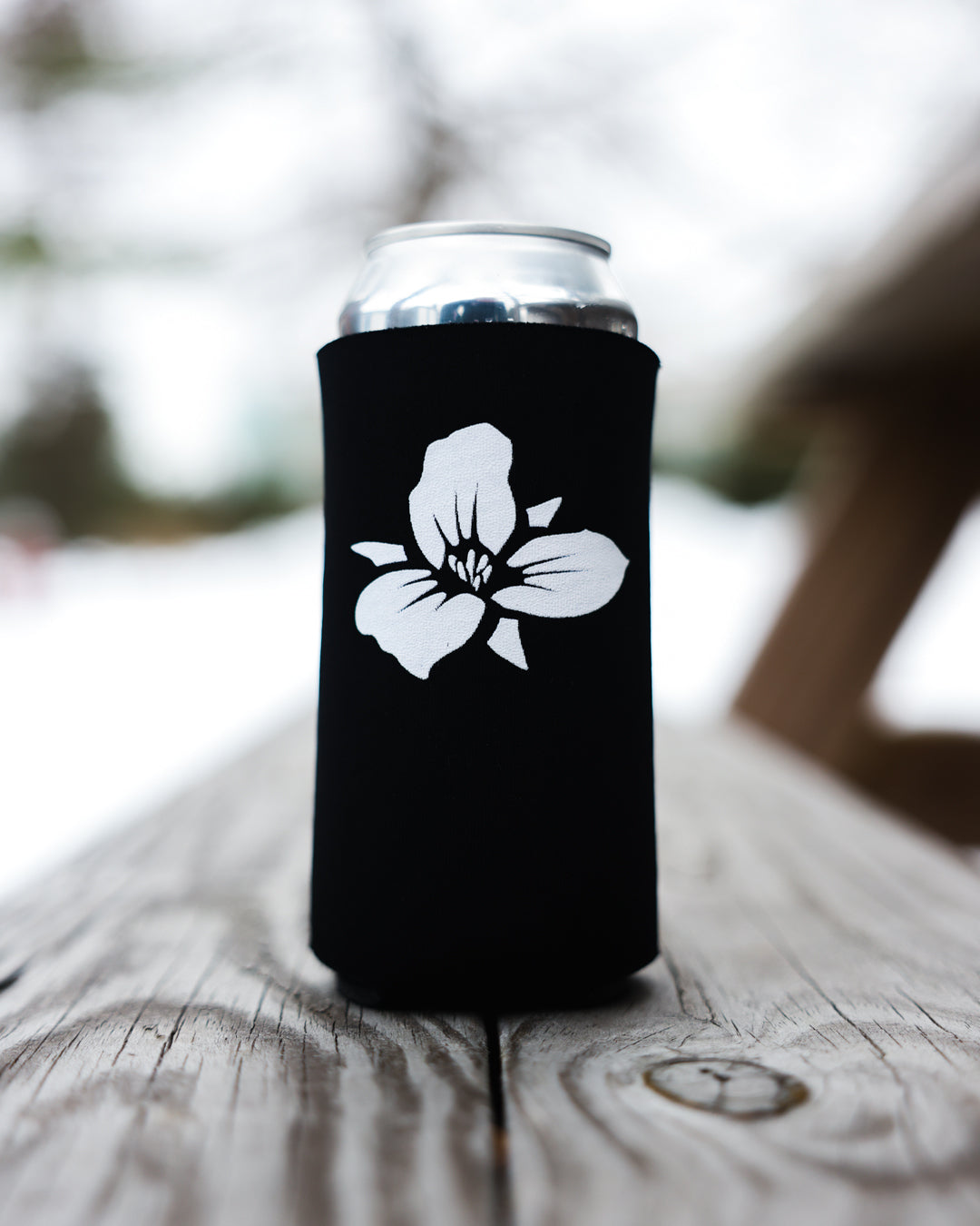 Trillium 16oz black koozie with white Trillium flower logo