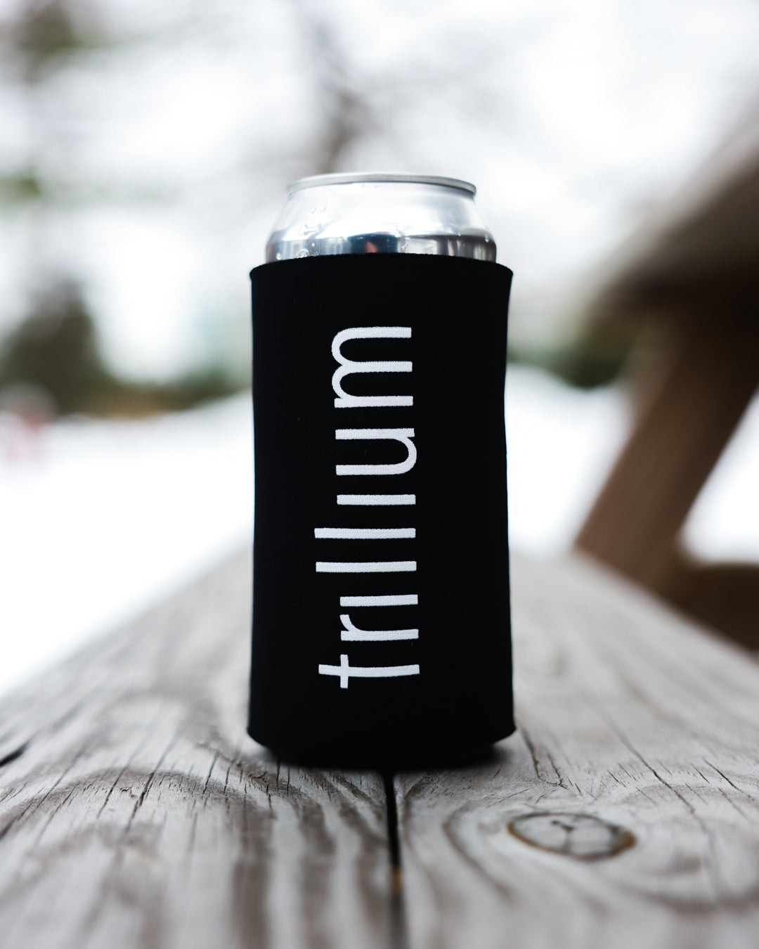 Trillium 16oz black koozie with white Trillium flower logo